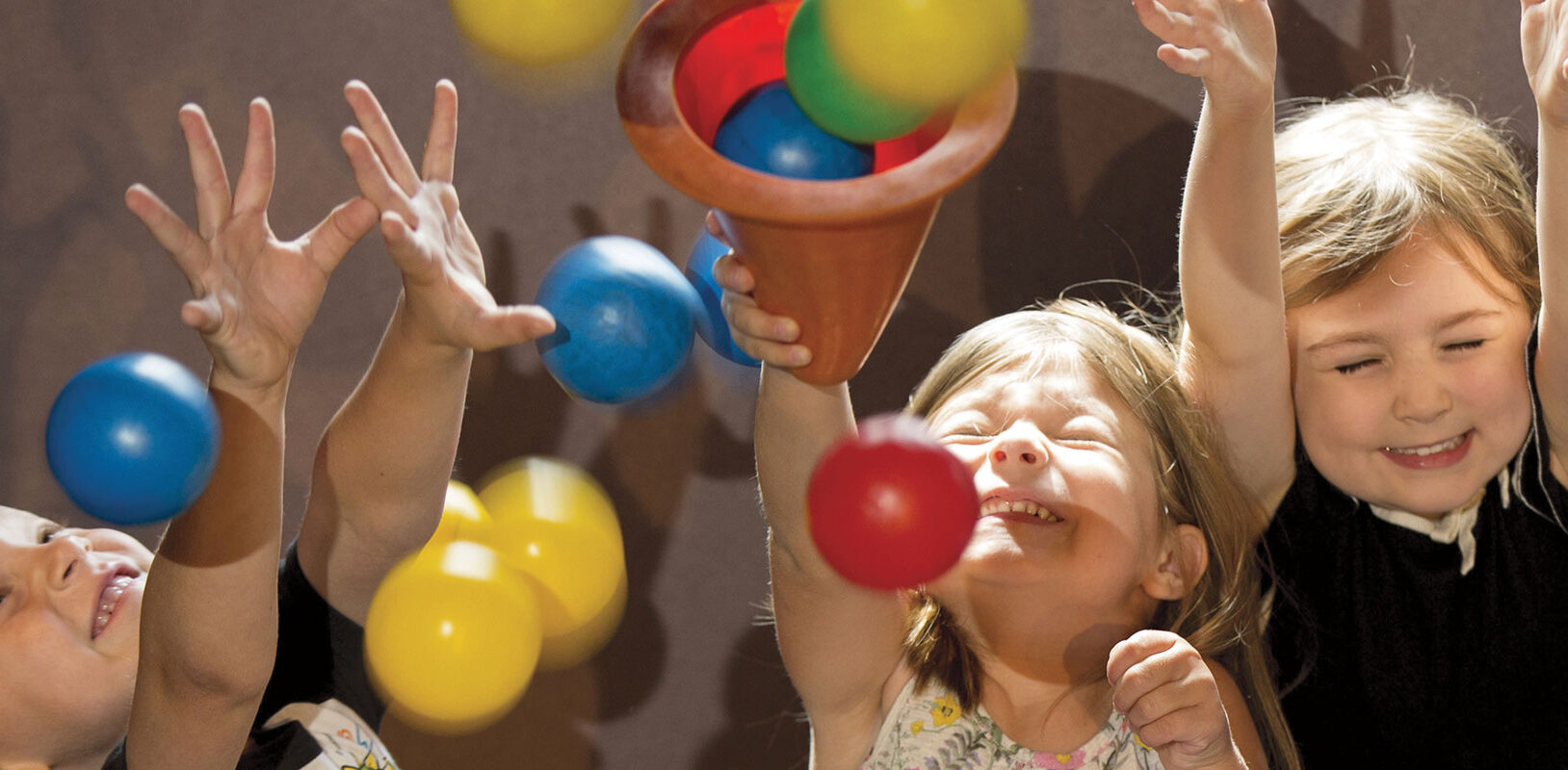 A group of small children laughing and playing at the Carnegie Science Center