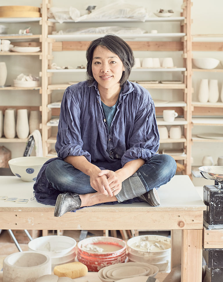 An ceramicist sitting in her studio.