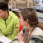A teen and a mentor working on a project.