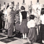 A black and white photo of an art class.
