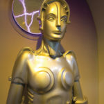 A gold colored female robot