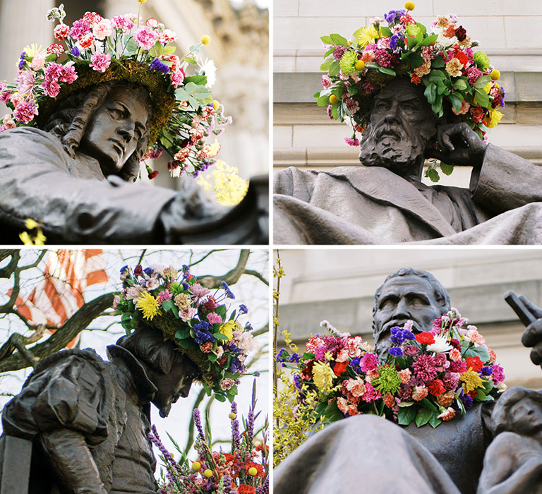 Four sculptures with various flower arrangements laced on them