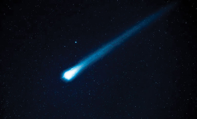 A comet traveling through a dark, starry background.