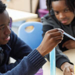A group of teens engaged in a science experiment
