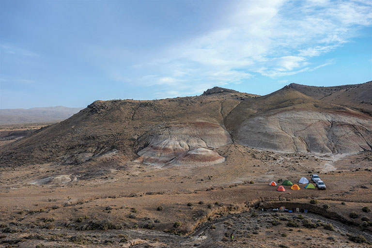A panaramic view of a campsite in a large desolate area.