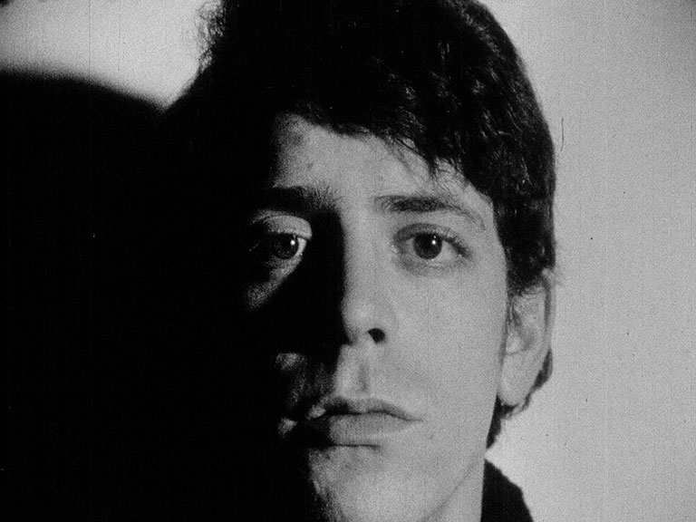 Black and white film still of Lou Reed