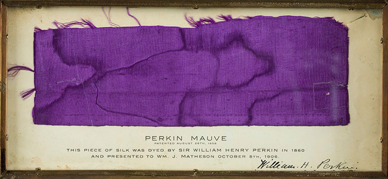 Framed silk sample dyed "Perkin Mauve," patented in 1856, with a detailed description of its history and presentation.