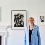 Woman in blue blazer standing in art gallery