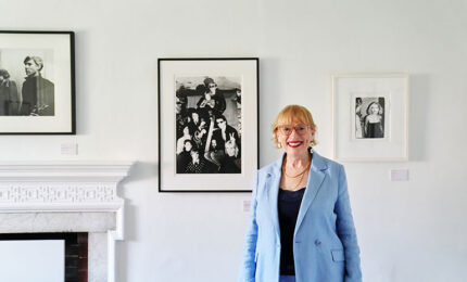 Woman in blue blazer standing in art gallery