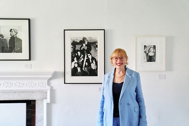 Woman in blue blazer standing in art gallery