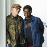 Two people standing together in casual clothing