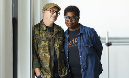Two people standing together in casual clothing