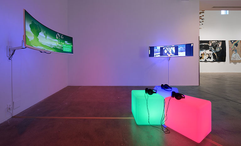 Interactive art installation with glowing cubes and screens