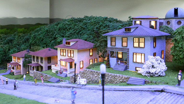 A detail view of a miniature model of a row of houses.