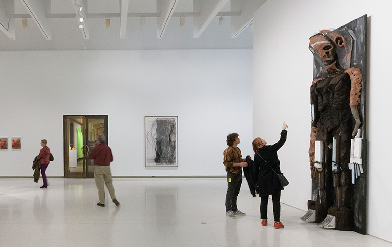 people viewing artwork in a gallery