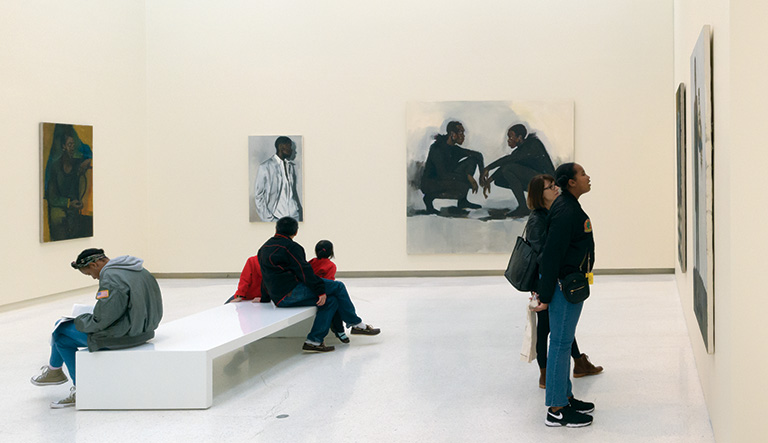 museum vistors viewing artwork in a gallery