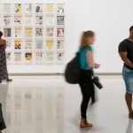 People viewing an exhibit in the art museum.