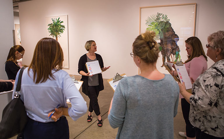 A woman giving a tour of a museum gallery