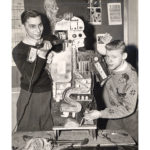 A vintage photo of 2 male students with a science project.