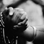 A photo fo two woman's hands clasped together.