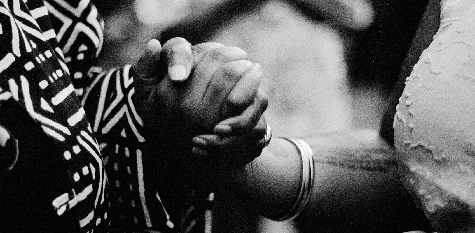 A photo fo two woman's hands clasped together.