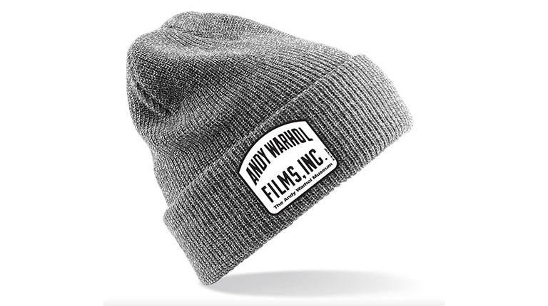 A gray ski cap with tag labeled Warhol Films