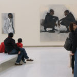 People in an art museum gallery looking at paintings