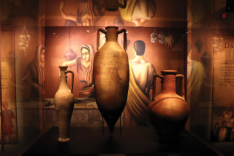 A view of 3 ancient vases in an installation