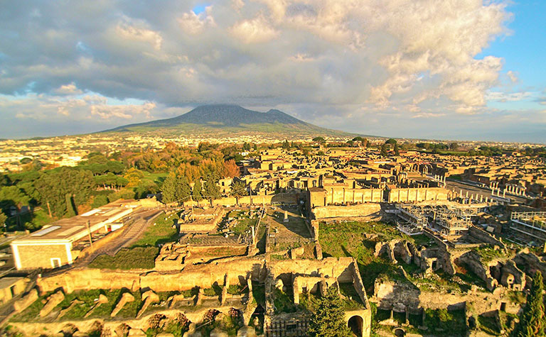 Panoramic view of the city of pompeii with mt vesuvius in the backgeround