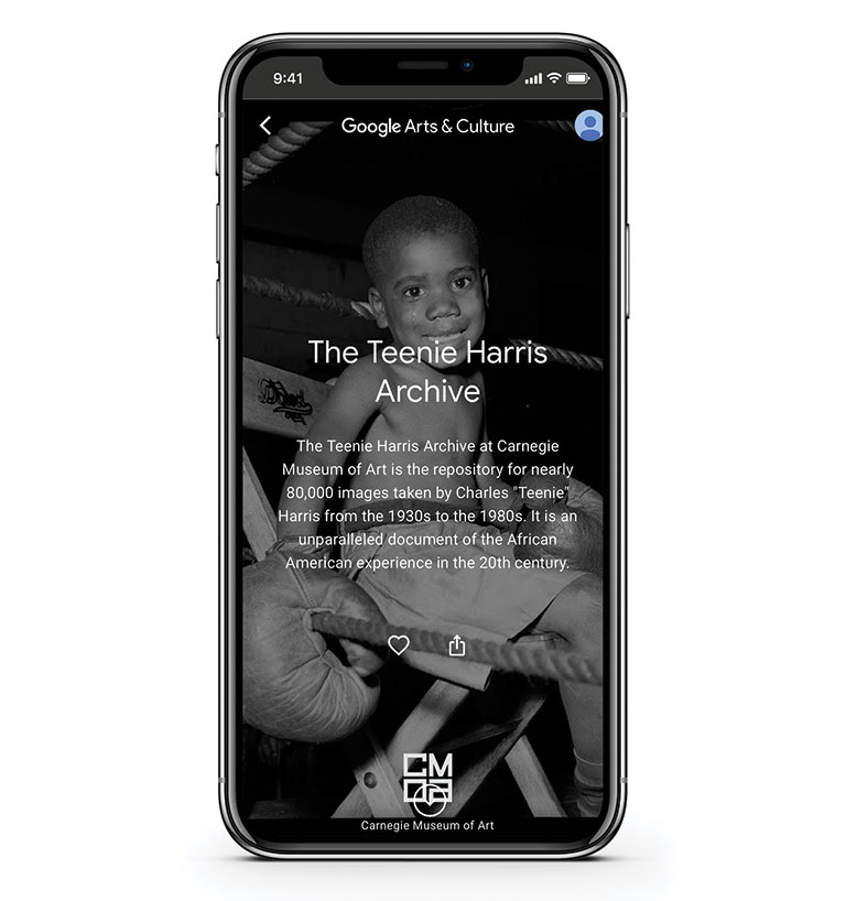 An iphone with a Teenie Harris photo of a young boy wearing boxing gloves