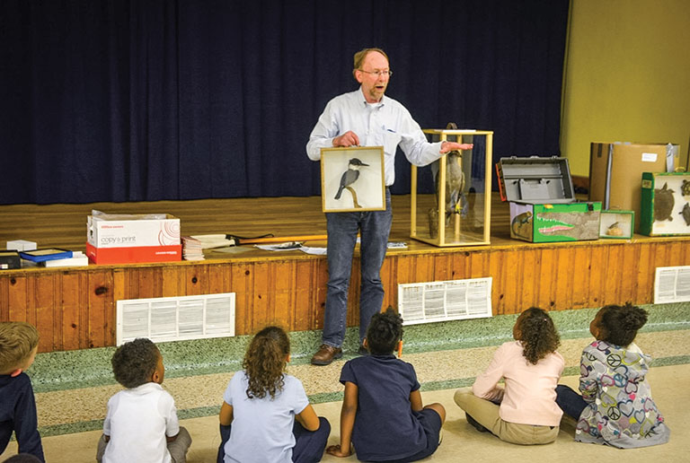 An educator presenting at a school program