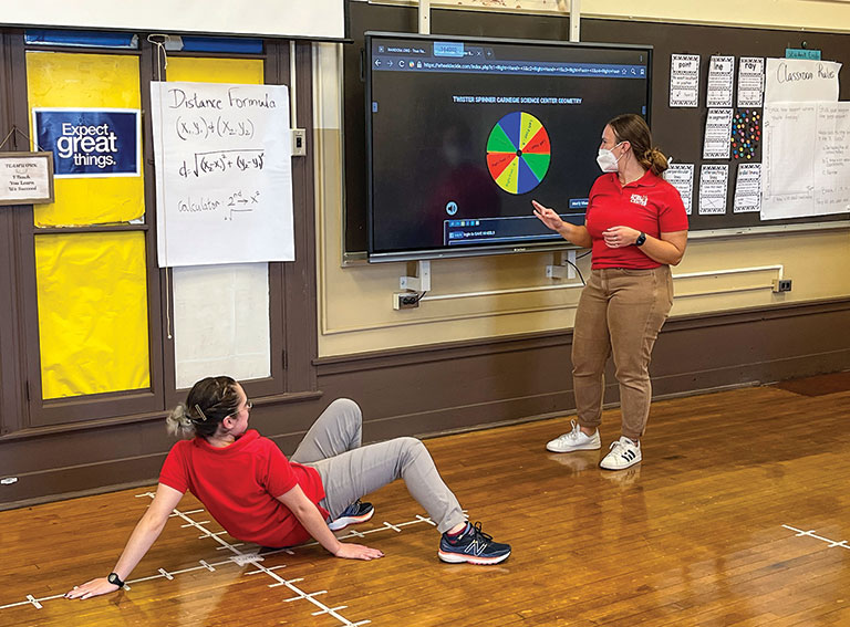 Educators demonstrating a modified game of twister