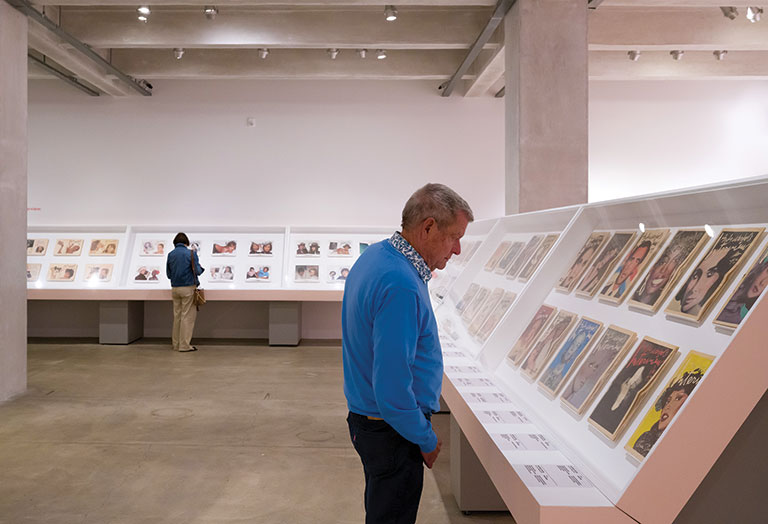 Man looking at rows of magazines on display