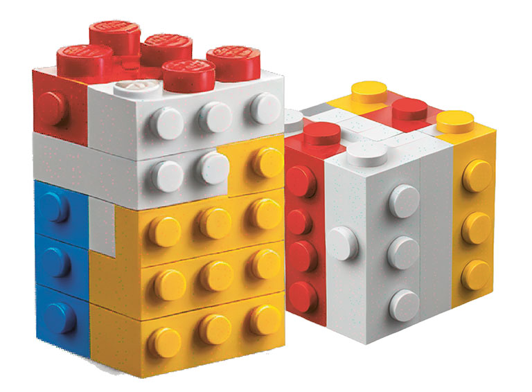 A colorful stack of LEGO bricks featuring red, yellow, blue, and white pieces arranged in various horizontal layers.